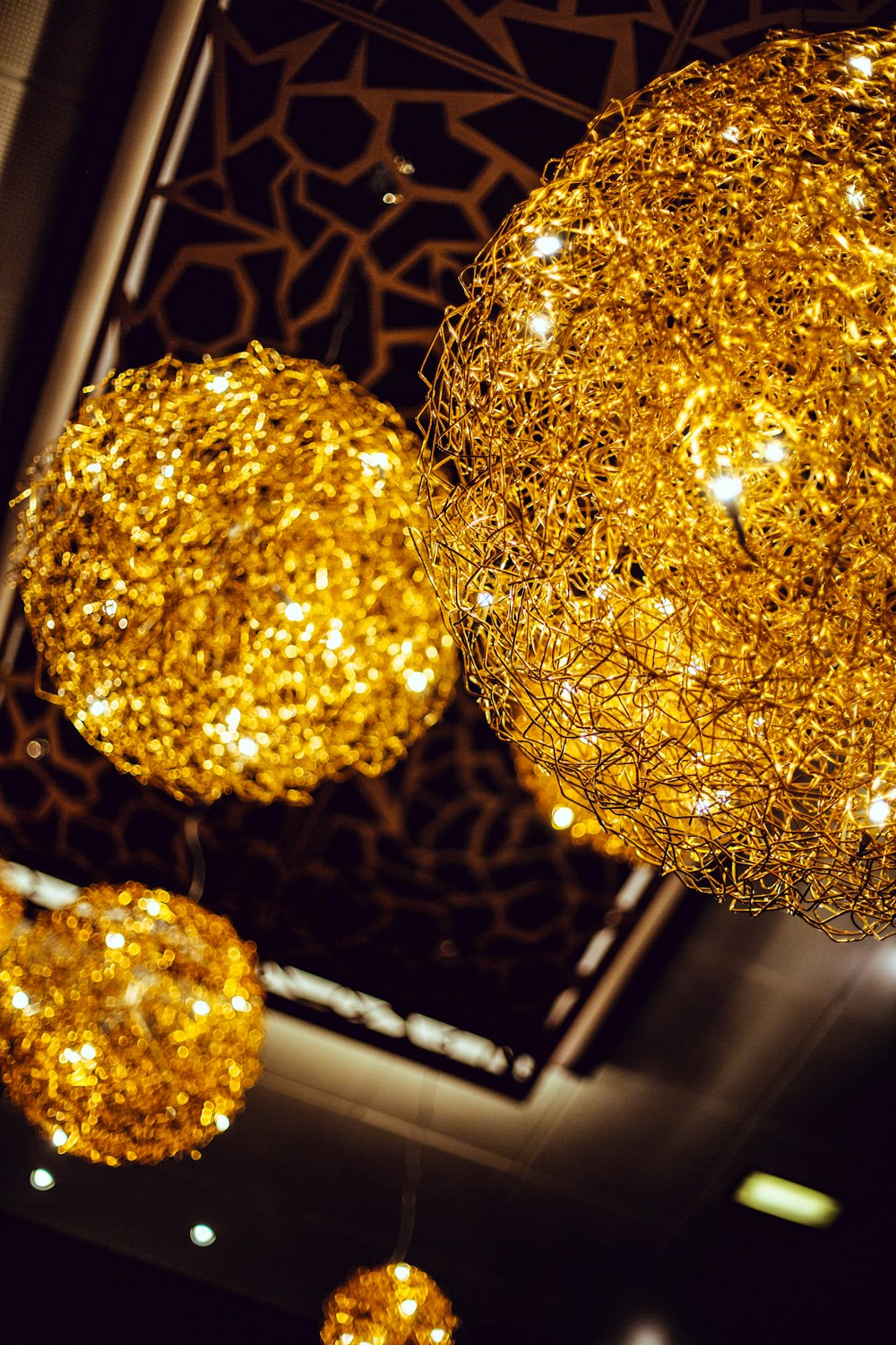 shallow focus photography of gold-colored pendant lamps