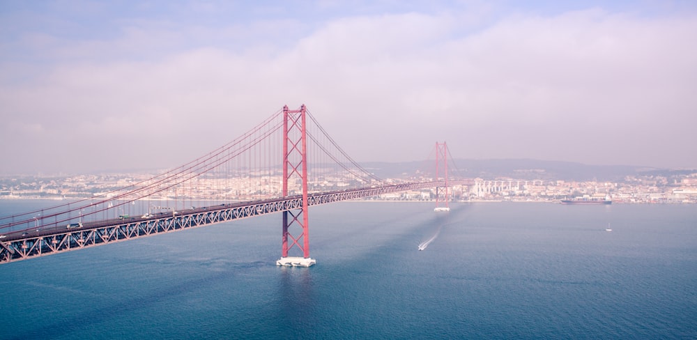 photography of red and gray bridge during daytime