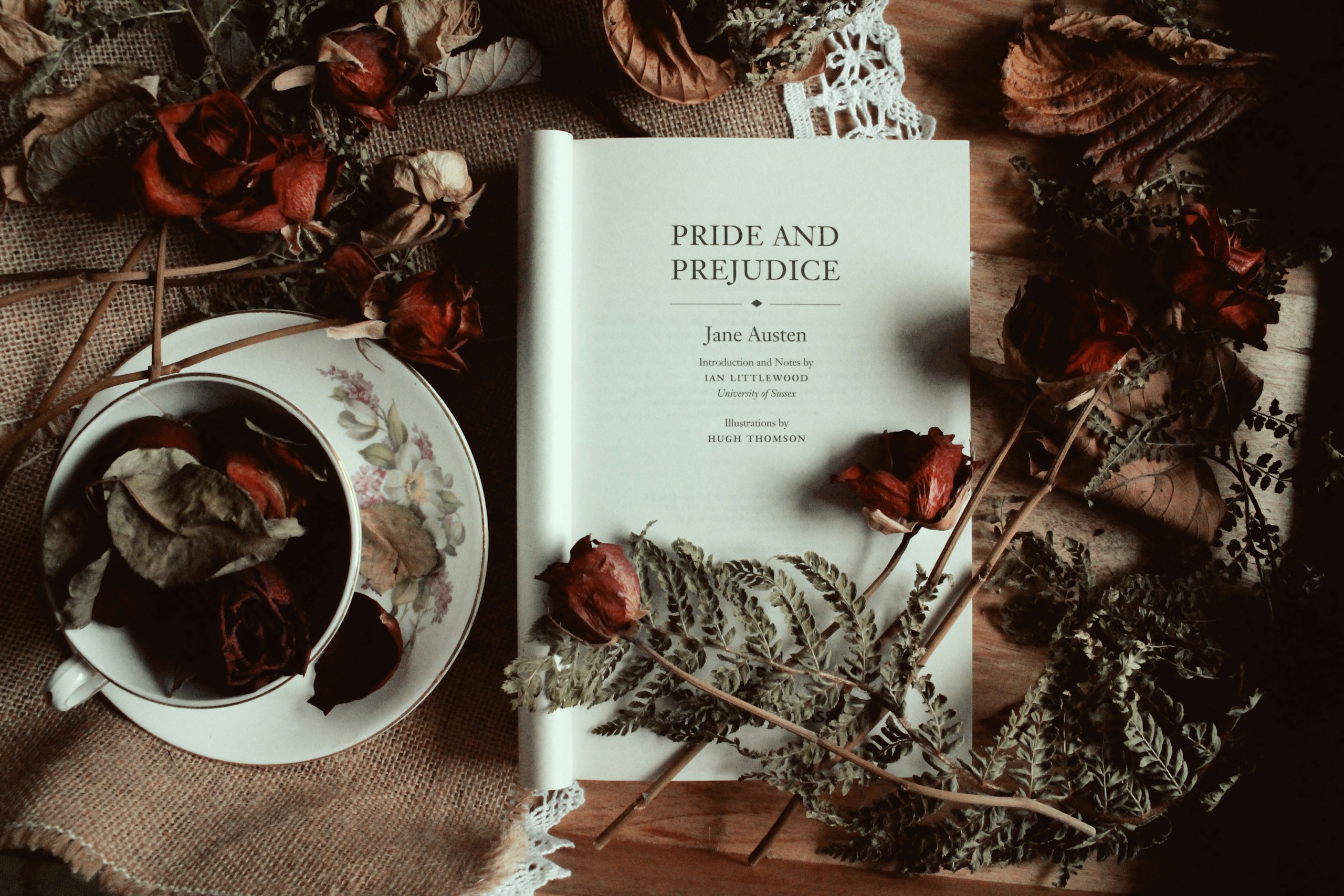 Pride and Prejudice by Jane Austen title page with dried Autumn leaves and roses and a teacup.