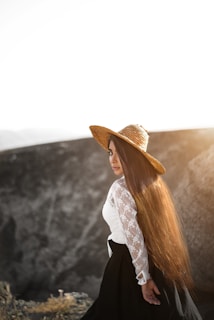 A model wearing a delicate crochet sun hat under soft sunlight.
