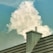 A large, fluffy cloud rises majestically in the sky, framed by a clear, blue background. In the foreground, a modern metal roof with a chimney adds an industrial contrast against the natural softness of the cloud.