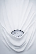round black clock on linen