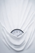 round black clock on linen