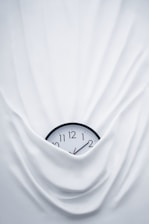 round black clock on linen