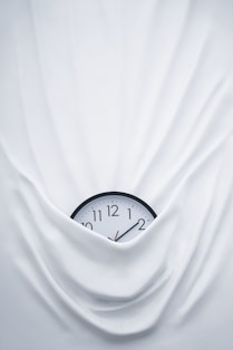 round black clock on linen