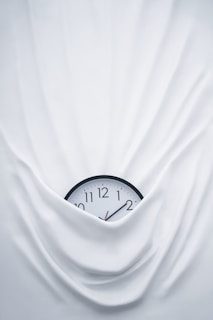 round black clock on linen