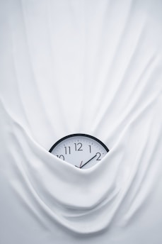 round black clock on linen
