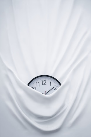 round black clock on linen