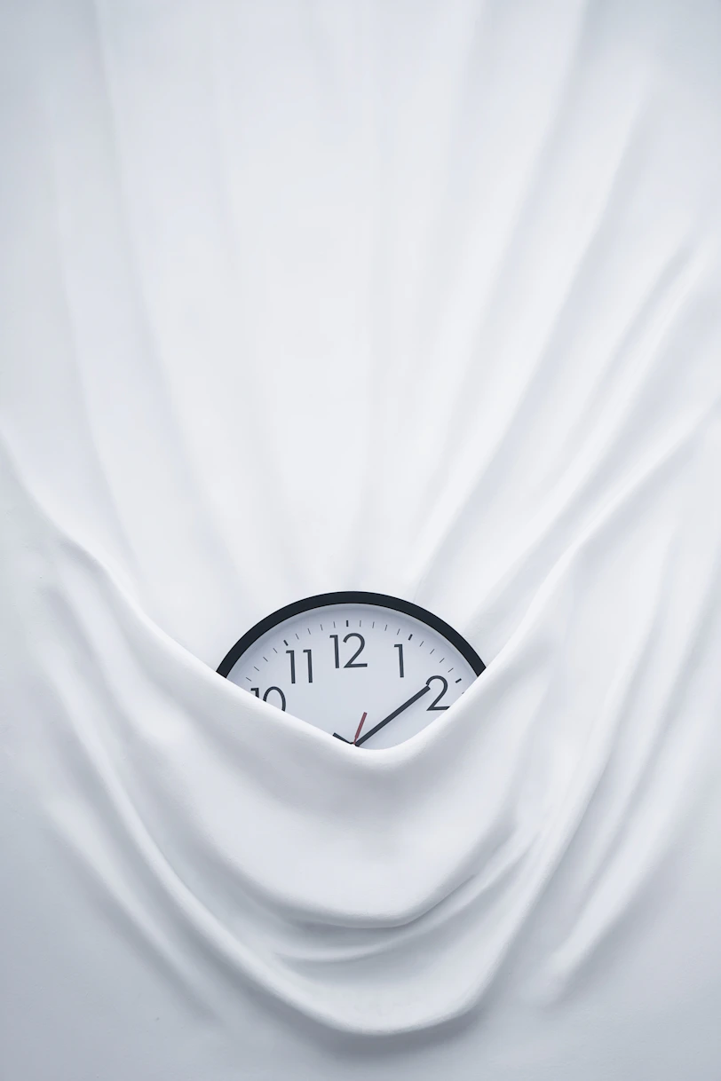 round black clock on linen