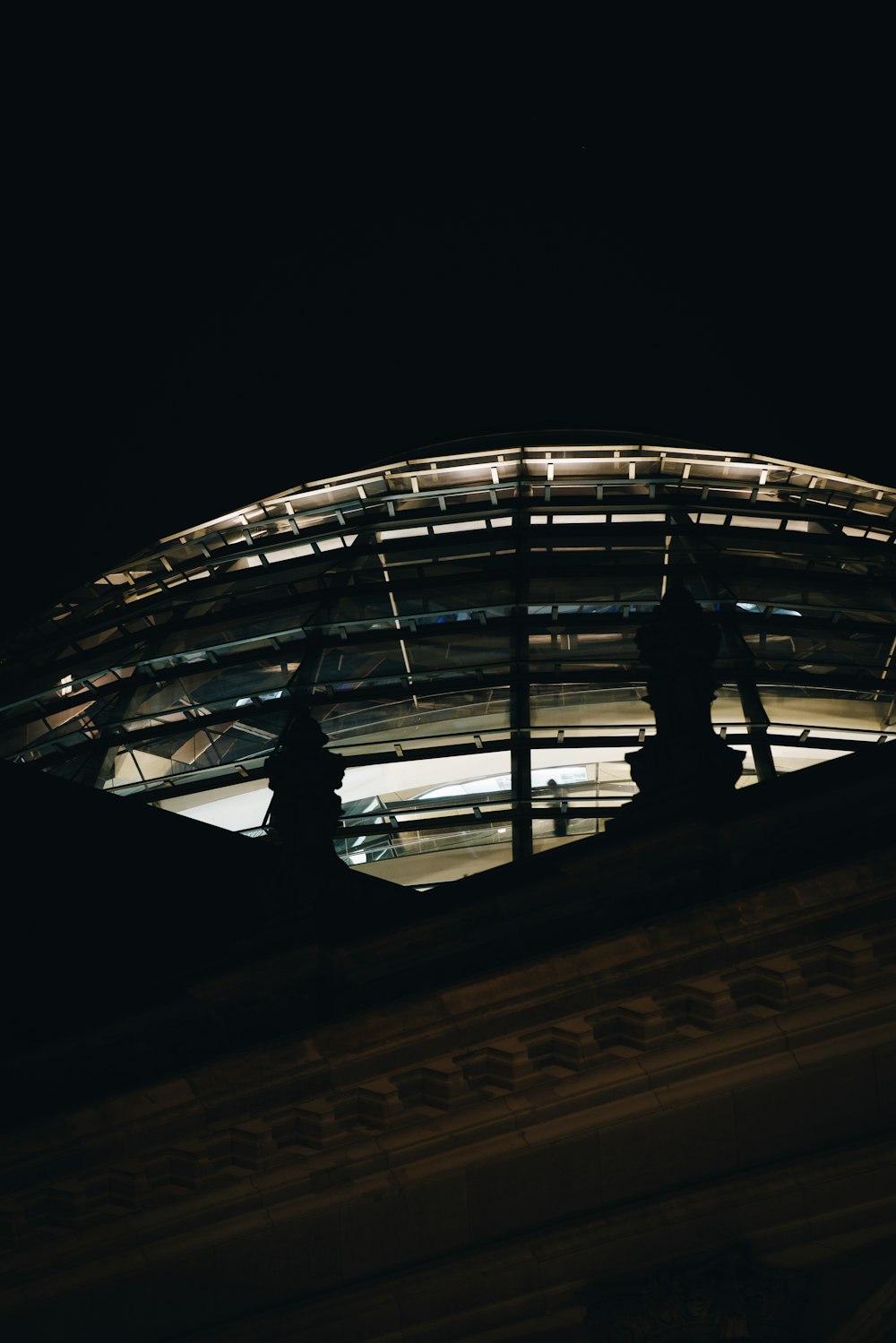 low-angle photograph of metal and concrete structure at night