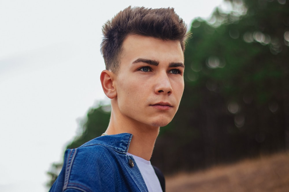 man wearing blue denim jacket