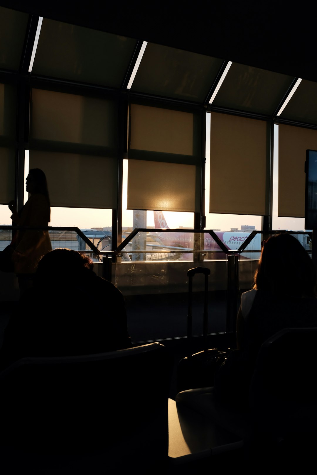 silhouette of person standing beside window