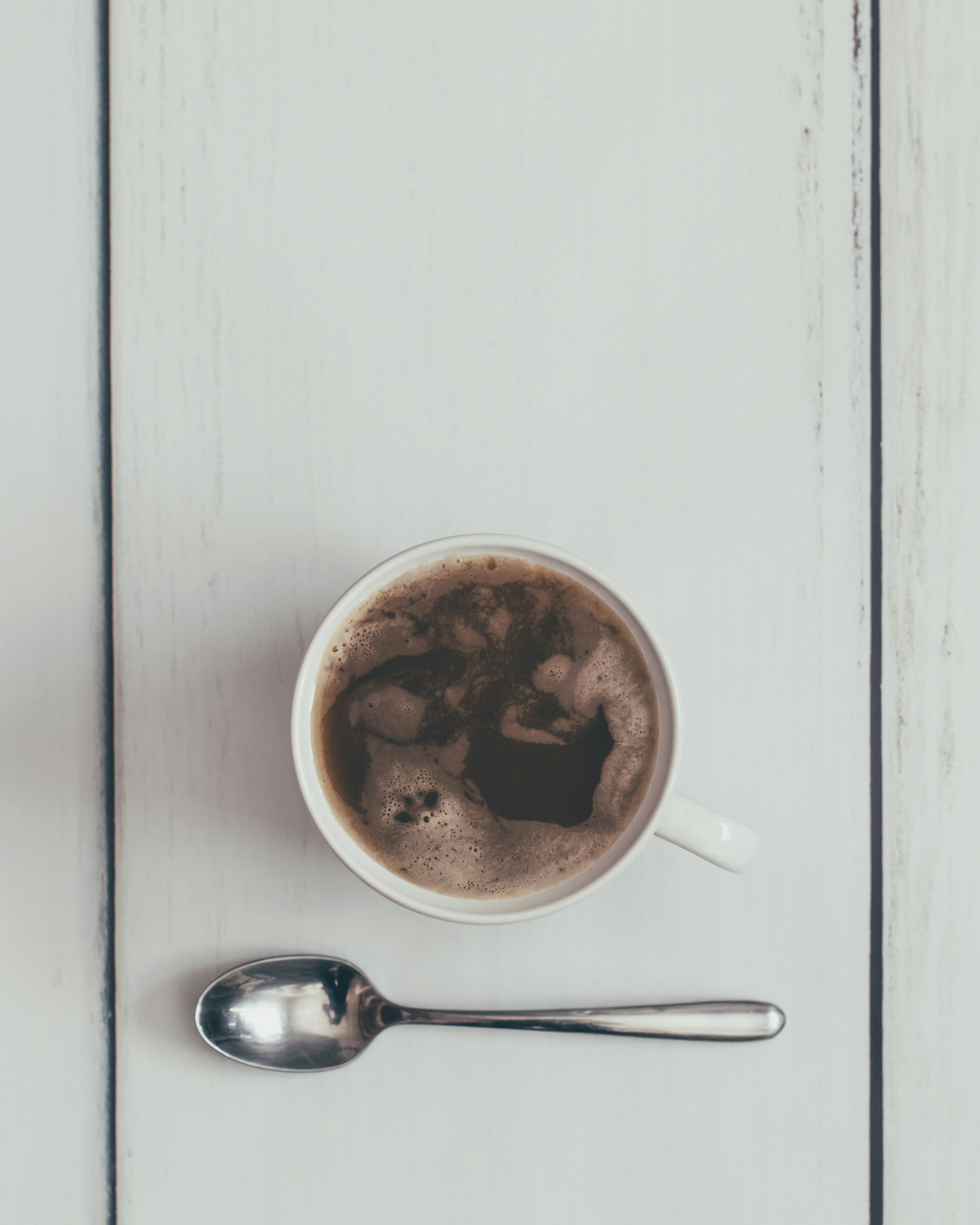 coffee filled teacup by teaspoon