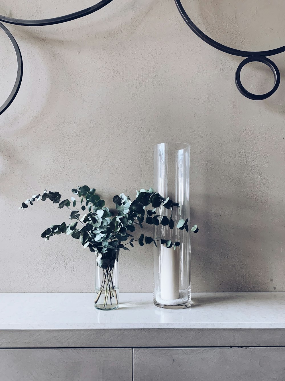 green plant in vase and glass holder