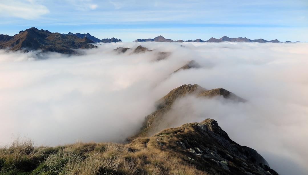 view photography of white fogs in mountain during daytime