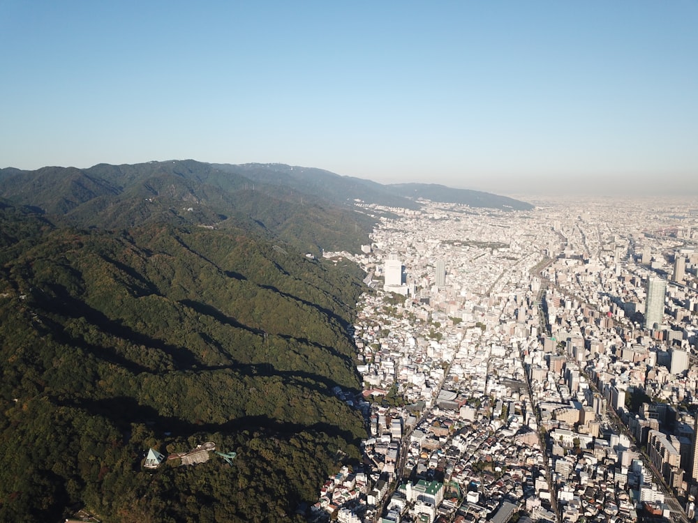 green mountain beside city buildings