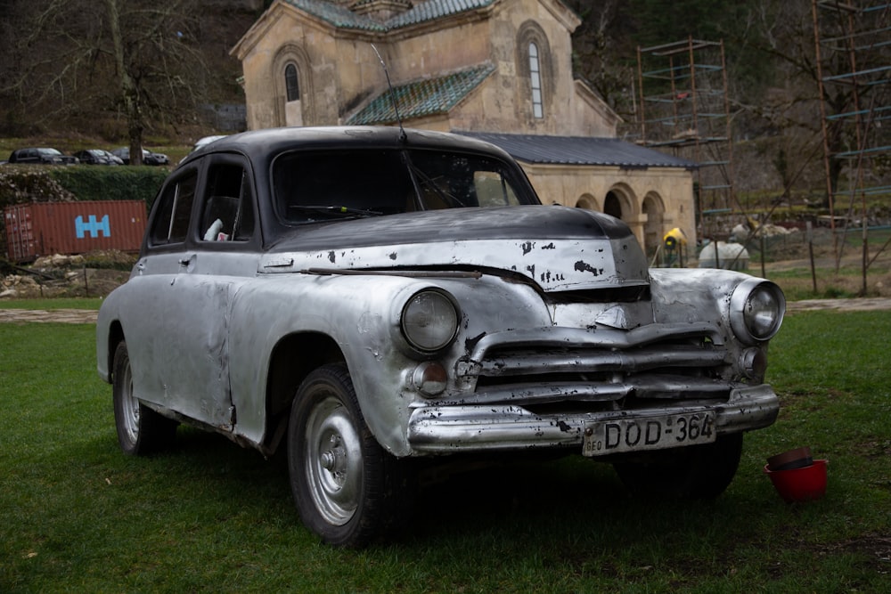 antique silver car on green field