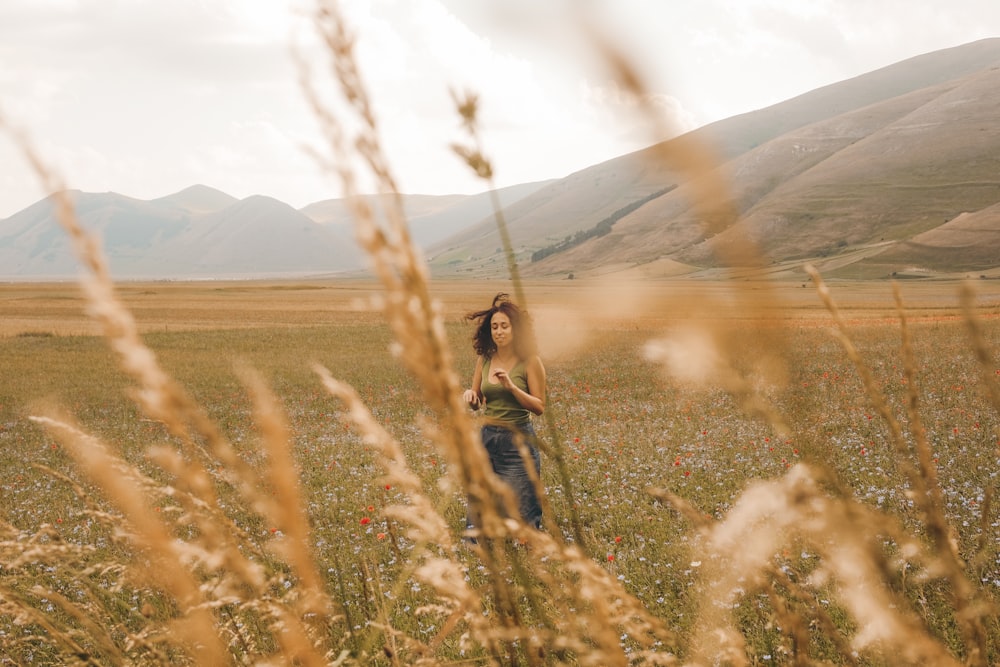 woman standing on green and brown field