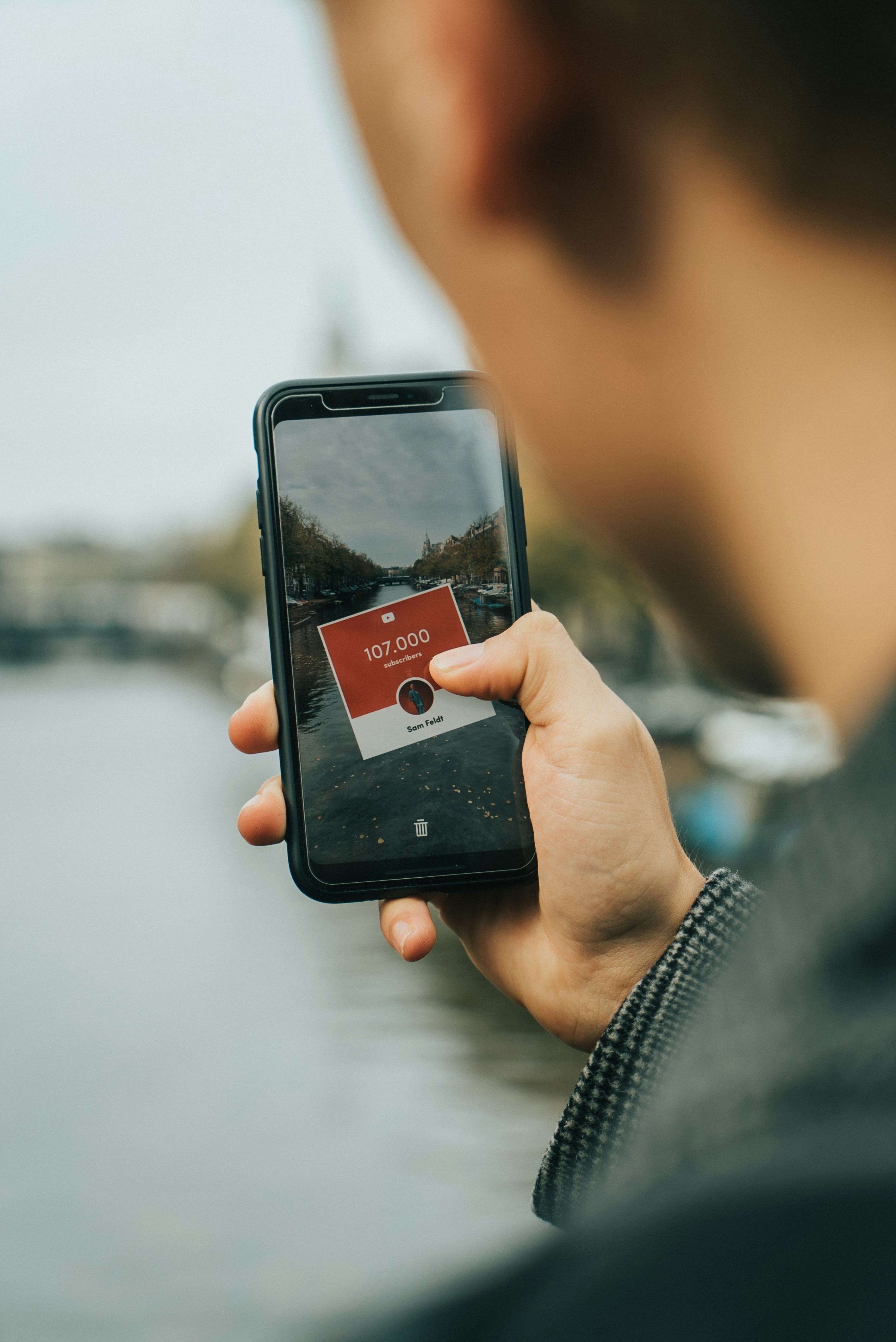 black Android smartphone taking photo of river