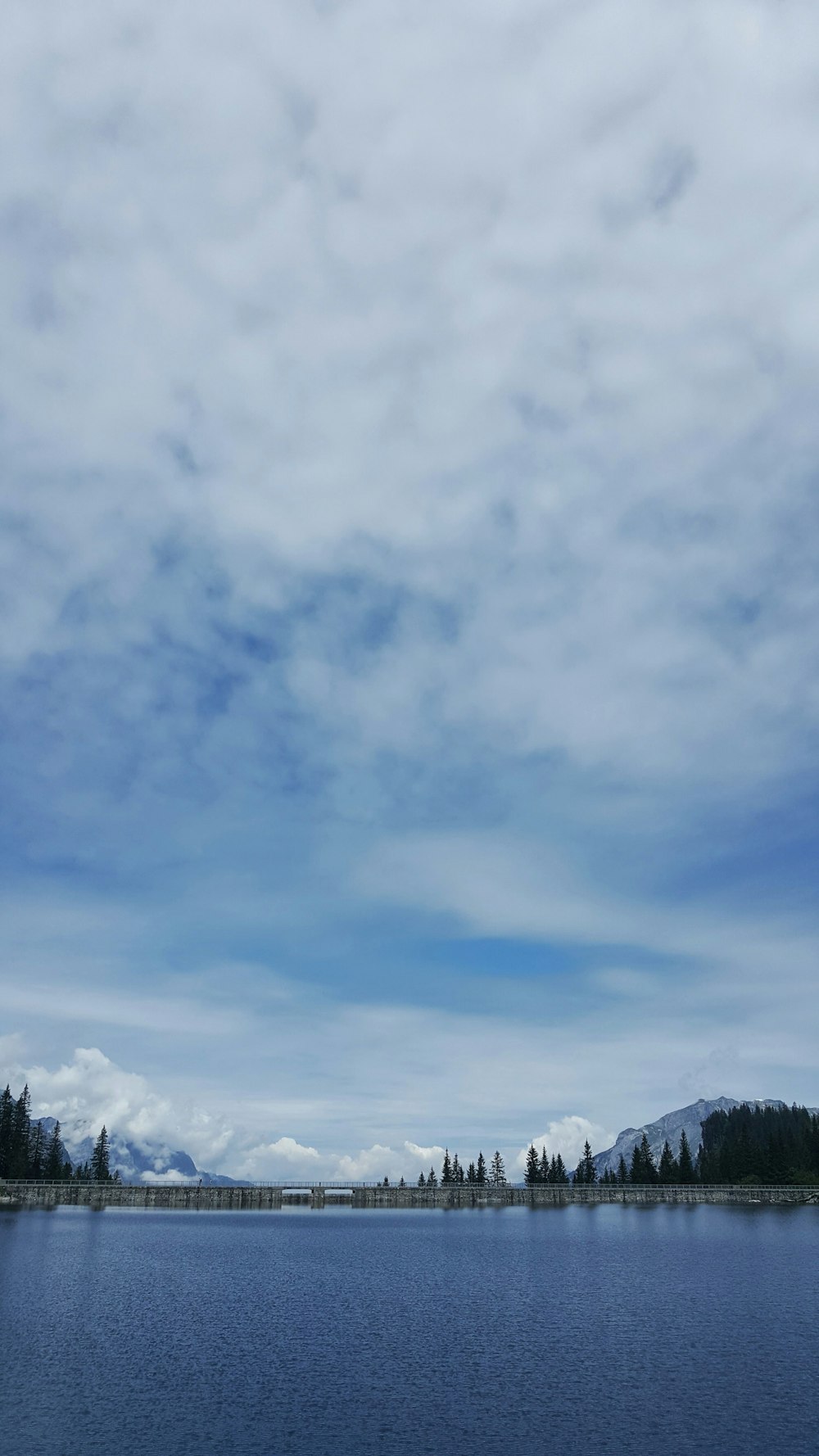 blue lake under white clouds