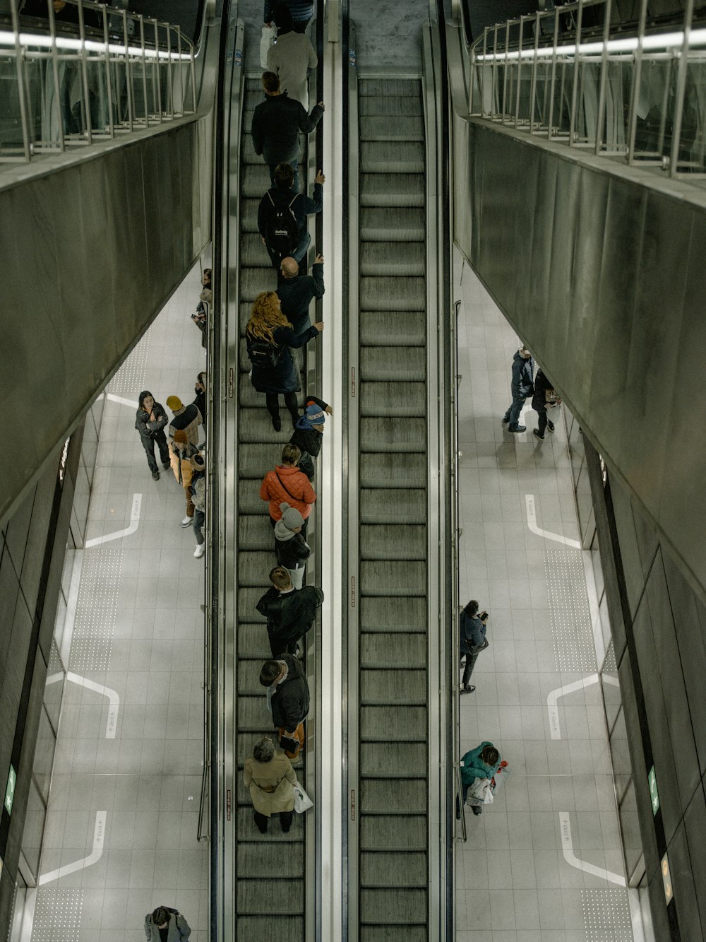people using escalator moving up