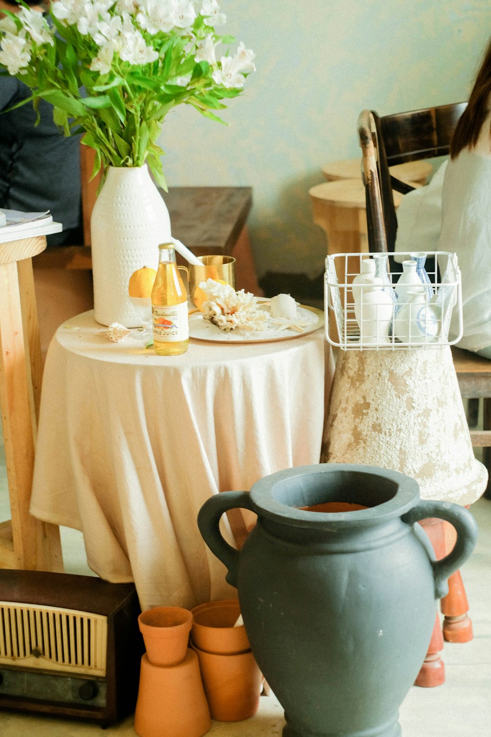 two gray vase beside table with tablecloth