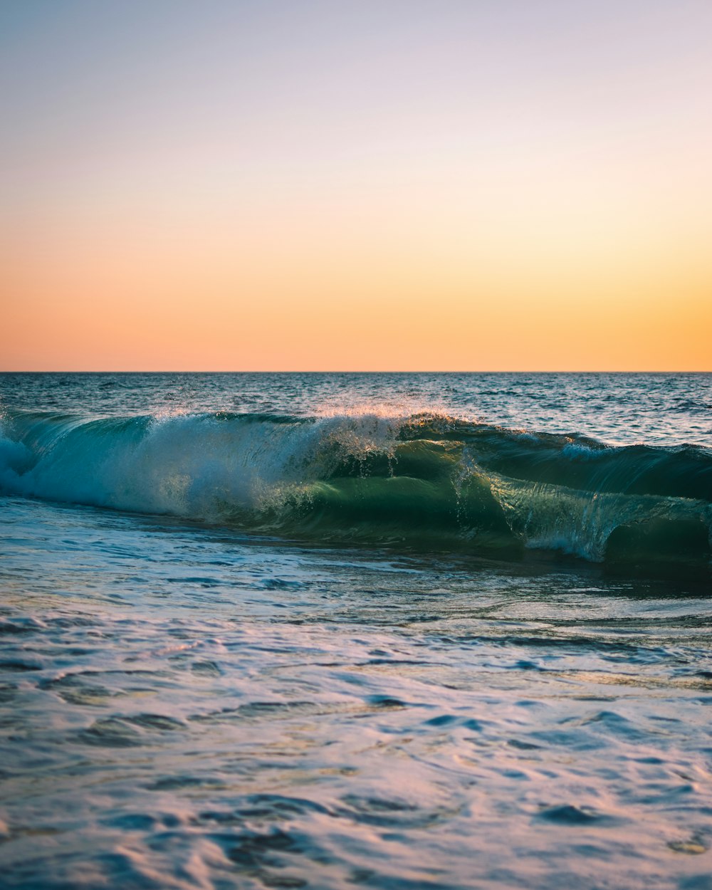 water wave under brown and white sky