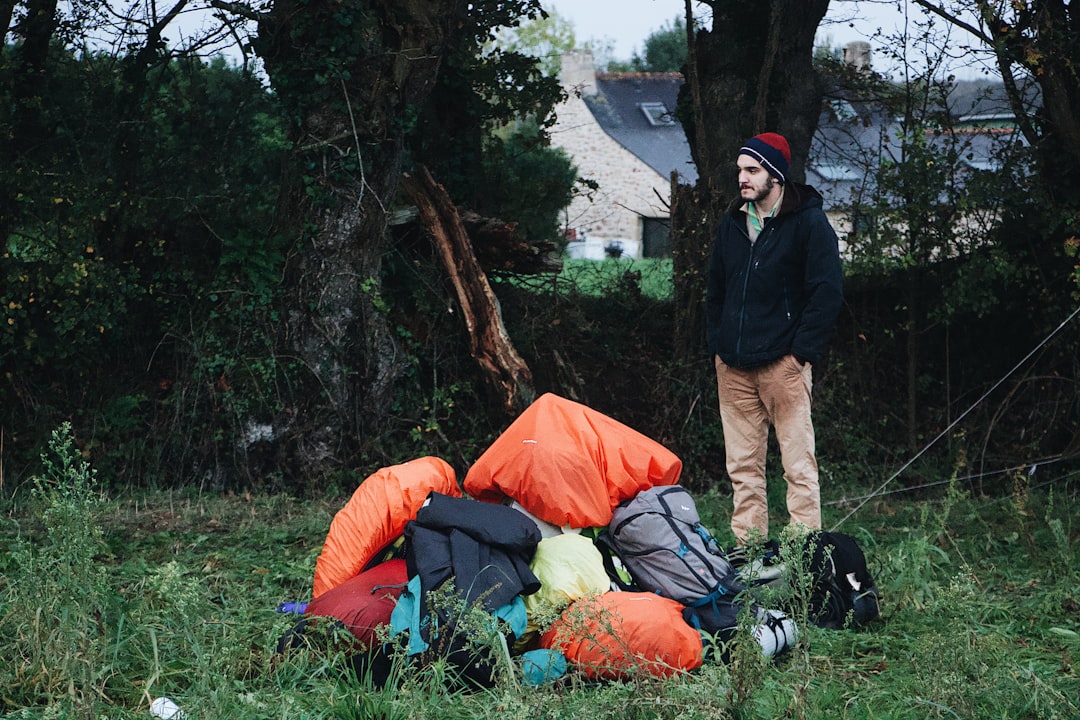 man standing near pile of bags