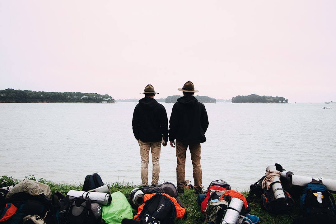 two men overlooking body of water