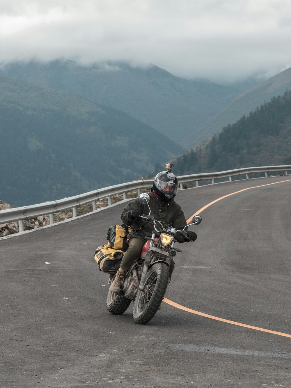 man riding motorcycle on road