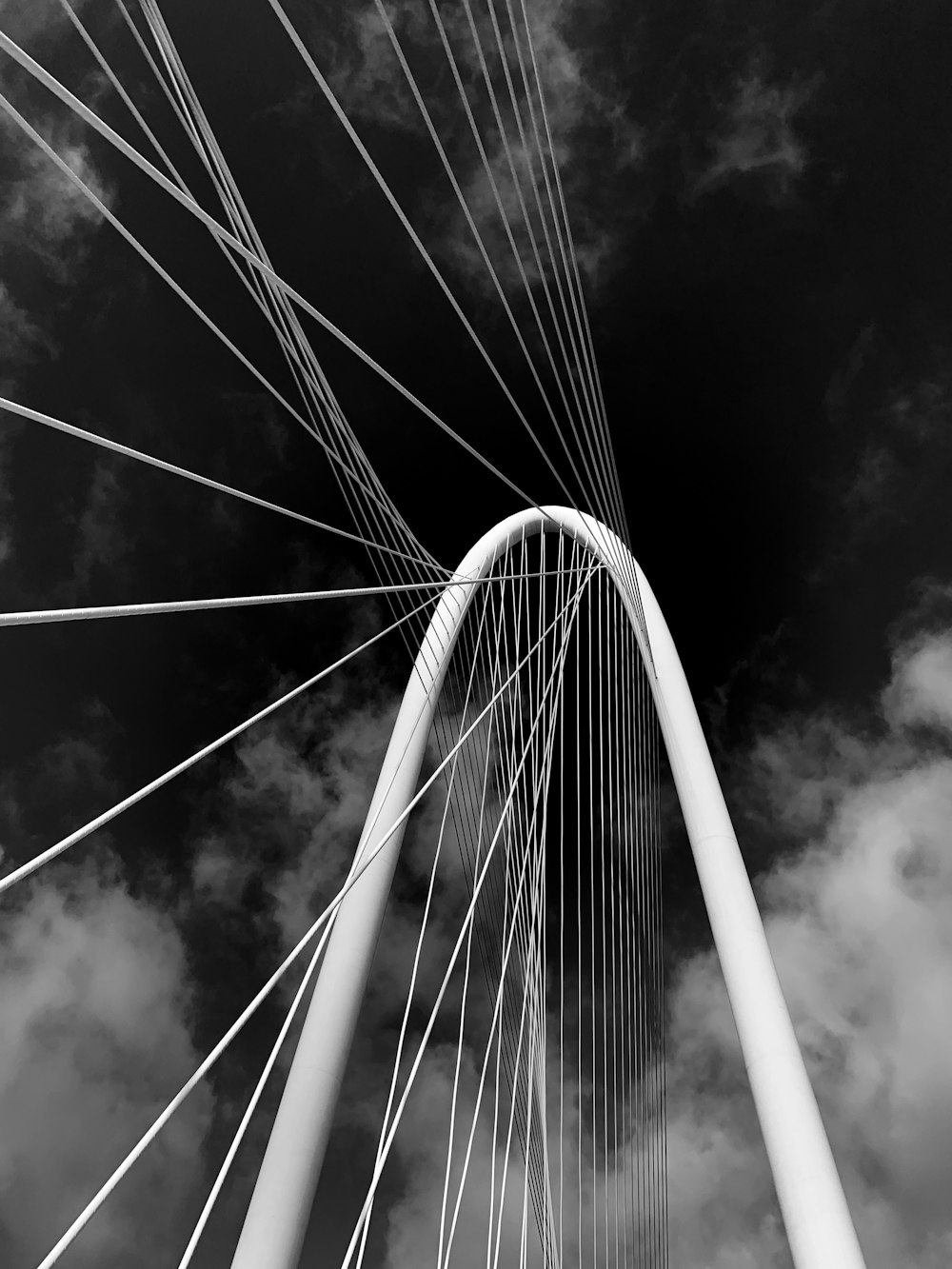 a black and white photo of a tall bridge