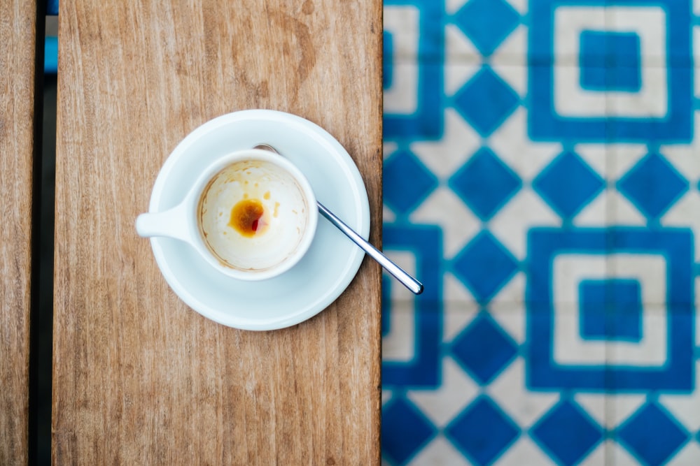 white ceramic mug on saucer