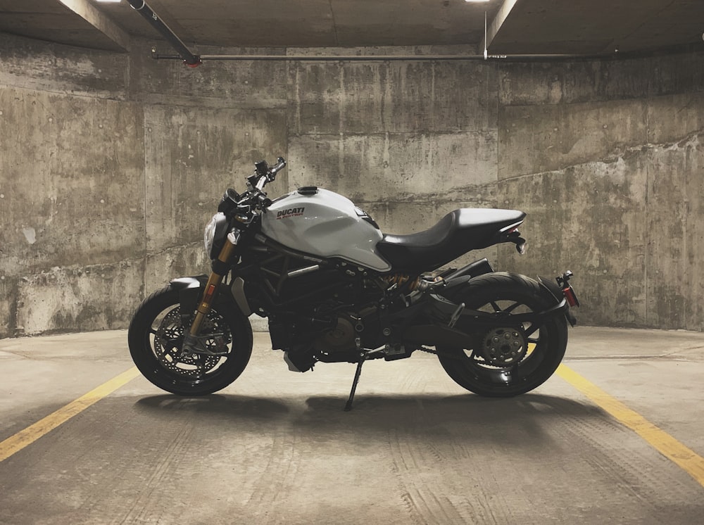 gray and black sports bike inside indoor parking lot