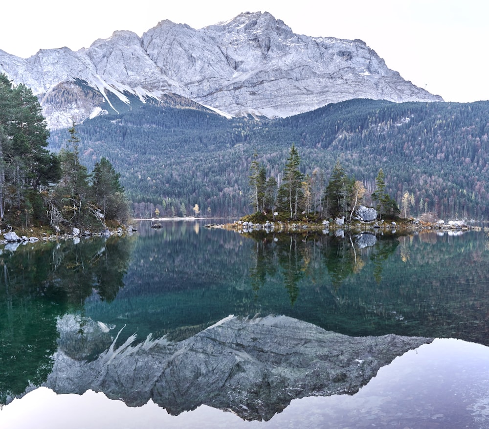 house near glacial lake viewing mountain during daytime