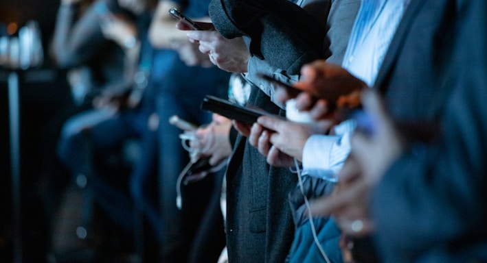 people using phone while standing