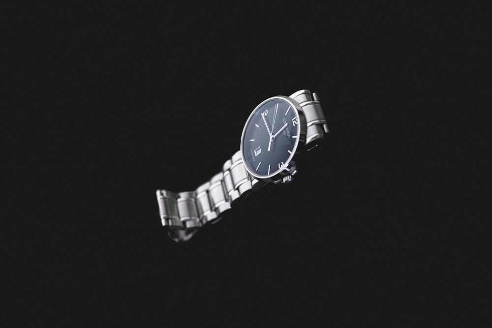 round silver-colored analog watch with link band