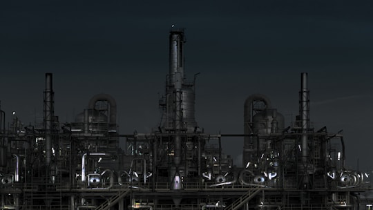 grayscale photography of factory at night