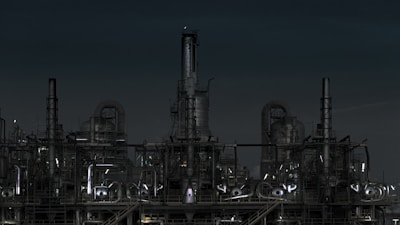 grayscale photography of factory at night