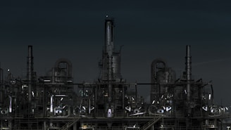grayscale photography of factory at night