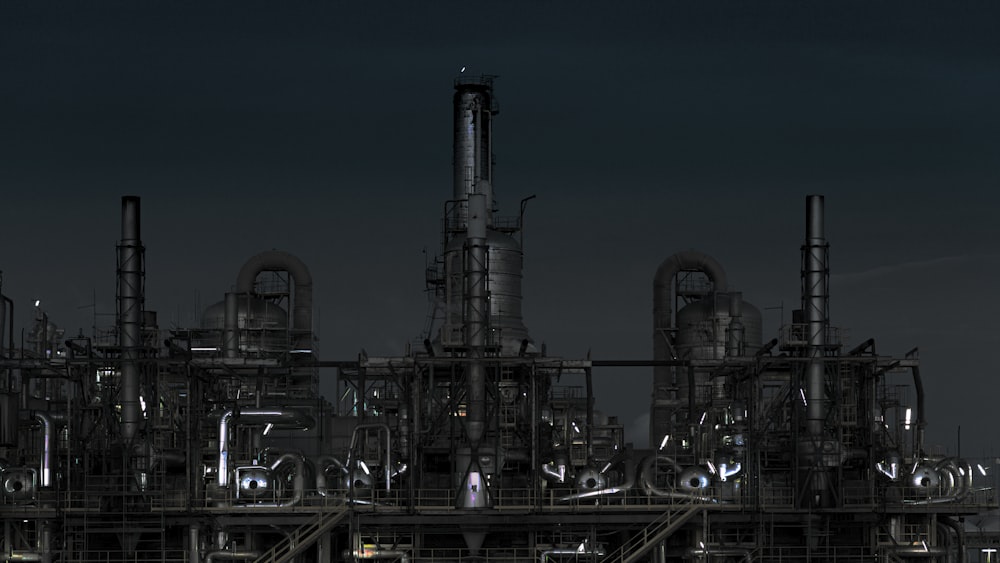 grayscale photography of factory at night