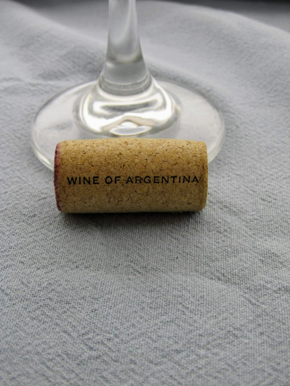 brown wine cork beside clear wine glass