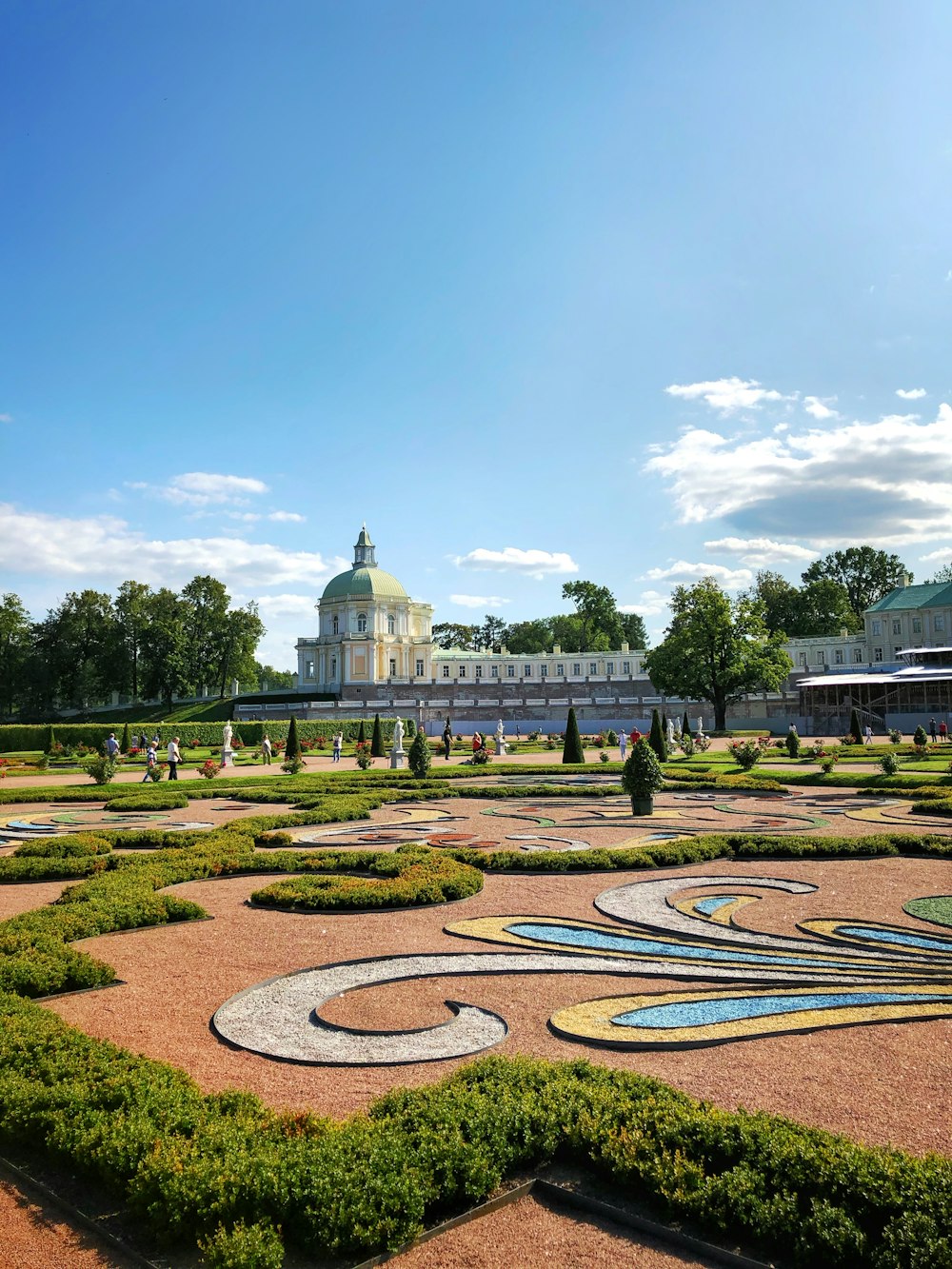 a view of a large building with a garden in front of it