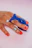 Close-up of a sleek beauty device held by a woman with manicured nails