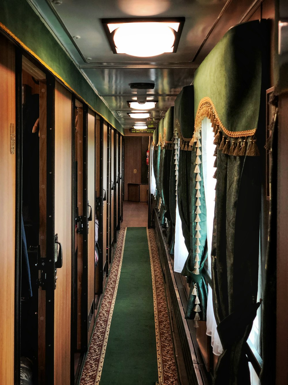 green hallway rug beside window