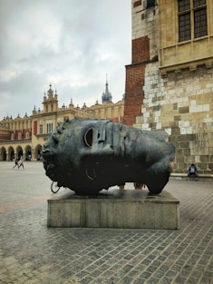 a sculpture of a shoe on a pedestal in front of a building