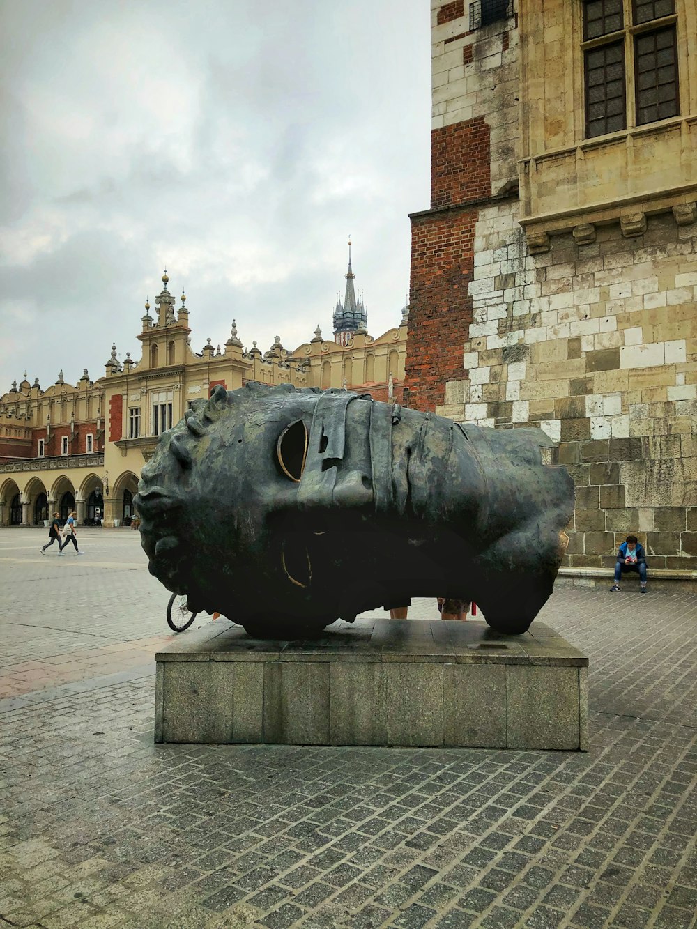 a sculpture of a shoe on a pedestal in front of a building