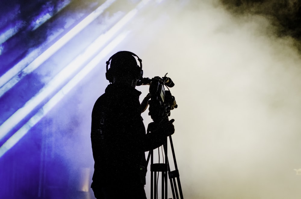 camera man stands near smoke