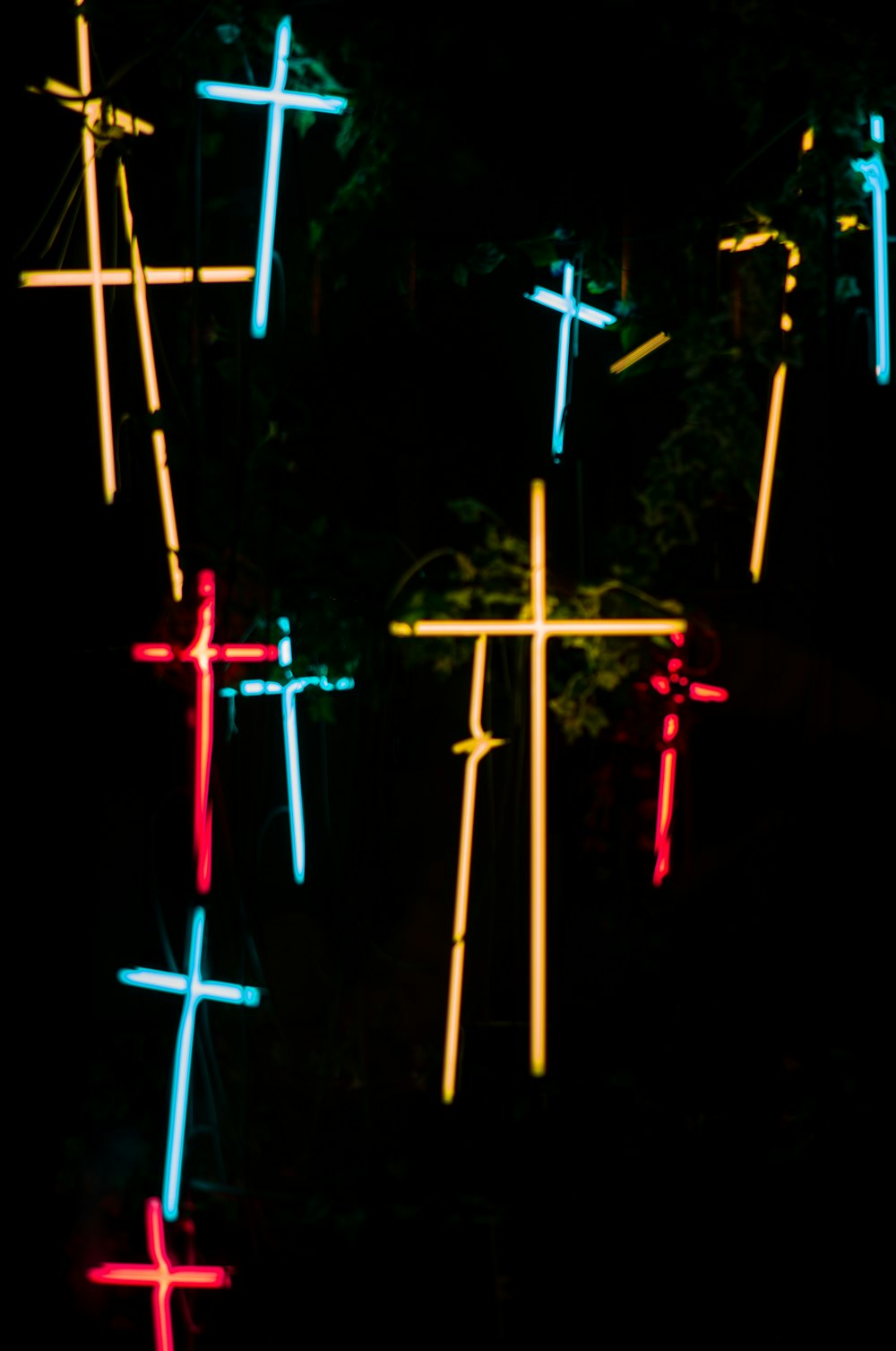 a bunch of crosses that are lit up in the dark