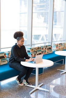 Portrait of a focused professional working on a digital tablet, surrounded by minimalist black and white decor.