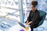 woman in black dress shirt using MacBook